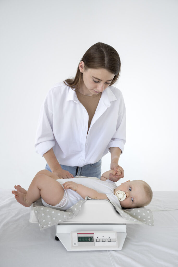adult taking care baby weight