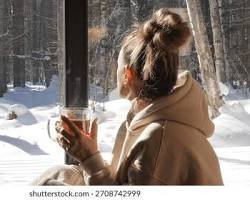 A warm cup of herbal tea placed near a window with soft sunlight