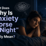 Woman lying awake in bed at night with anxious thoughts, moonlight through the window, and the text “Why Is Anxiety Worse at Night” displayed prominently.